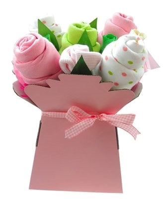 Say It Baby - Baby Girls Muslin Square Bouquet - Say It Baby. This lovely bouquet contains five muslin squares including baby pink, green and polka dot. The arrangement also contains x2 pairs of little baby socks, artificial wooden roses and greenery to look just like a pretty bouquet.