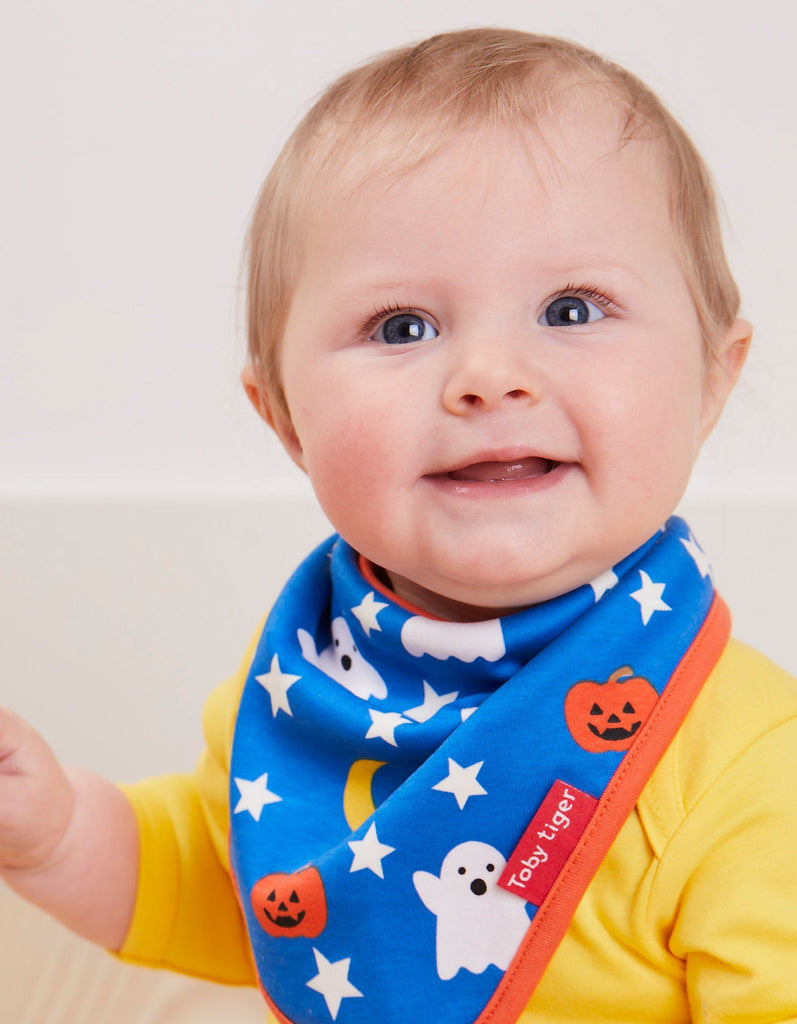 Toby Tiger Ghost Print Dribble Bib - A gorgeous bib that will keep your little pumpkin looking cute! This lovely bib in blue features friendly white ghosts and a sweet jack o'lantern and star print with a bold orange trim. -say it baby gifts
