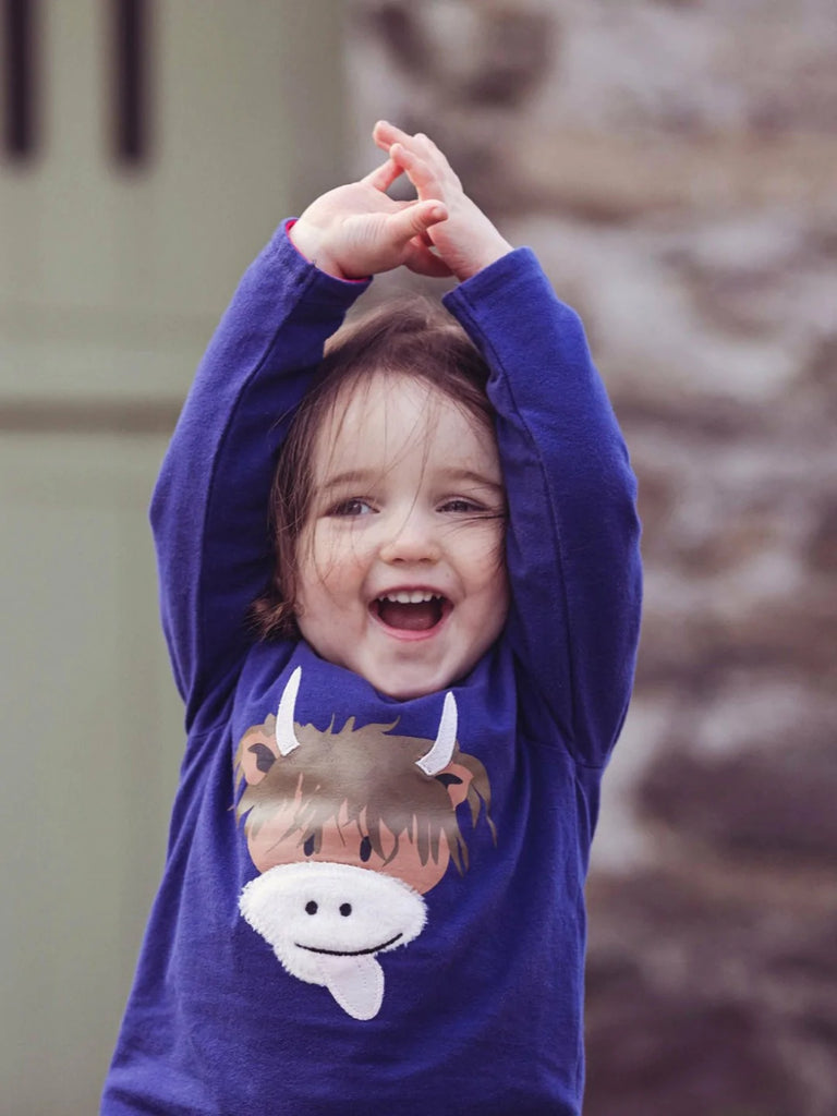 Blade & Rose Highland Cow Top - bold, bright and fun! This gorgeous navy top features a cute Highland Cow with a soft fleece nose.. Sold by Say It Baby Gifts