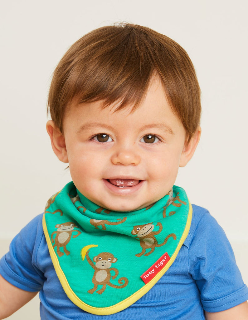 Toby Tiger Monkey Dribble Bib  - A gorgeous bib in green featuring cheeky monkey and bananas, with a bold yellow trim. Organic baby bib, Sold by Say It Baby Gifts