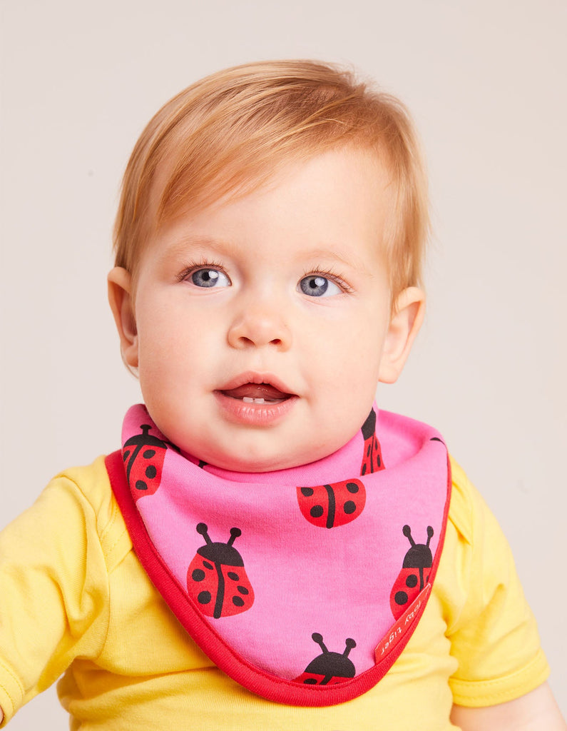 Toby Tiger Ladybird Dribble Bib - A gorgeous bib in pink featuring sweet ladybirds with a bold red trim. Sold by Say It Baby Gifts