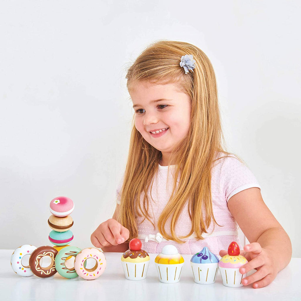 Le Toy Van Petit Four Cupcakes - Le Toy Van toys are all ethically made, using natural materials, including replenishable quality smooth rubber-wood and an array of techniques from hand screen printing to water staining. Their detailed hand-finished toys are unique and loved by little hands!