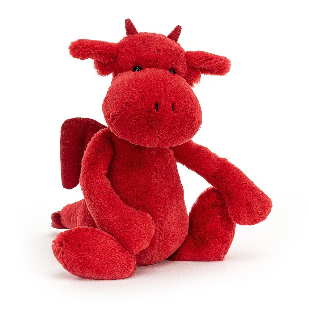 Jellycat Bashful Dragon is a roaringly cute little guy with fiery fur. Beautifully soft, he's ready to fly into your heart! Chunky and cheery, with a squishy snout and beautiful long tail, suedey horns and wings, this daring red dragon is ready for cuddles! Sold by Say It Baby Gifts