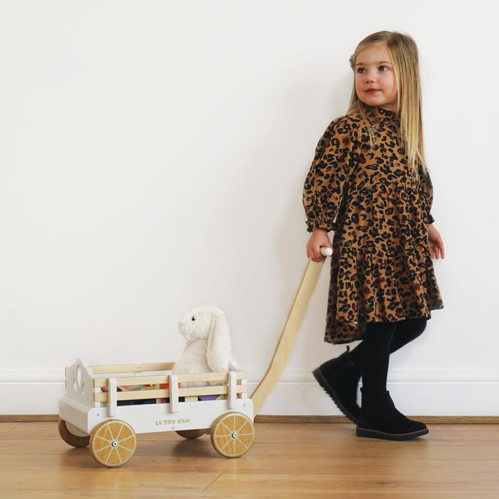 Le Toy Van Pull Along Wagon Cart. This timeless wagon is ideal for kids to collect, load and transport toys their around the house. This robust wagon is made from sustainable rubberwood and solid strong plywood and can be pulled along floors and carpets seamlessly.
