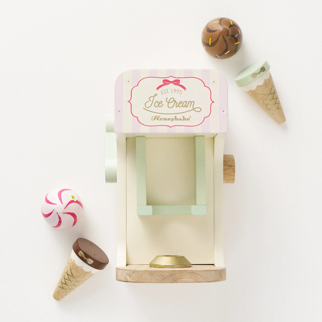 Whip up some fun this summer with this fantastic Le Toy Van Ice Cream Machine - perfect for imaginary play! Sold by Say it baby Gifts. The set includes a cone holder on the base, a moving lever and a functional flavour switch. When it’s time to serve up, use the 2 magnetic cones and ice cream tops (strawberry and chocolate) to delight your loyal customers.