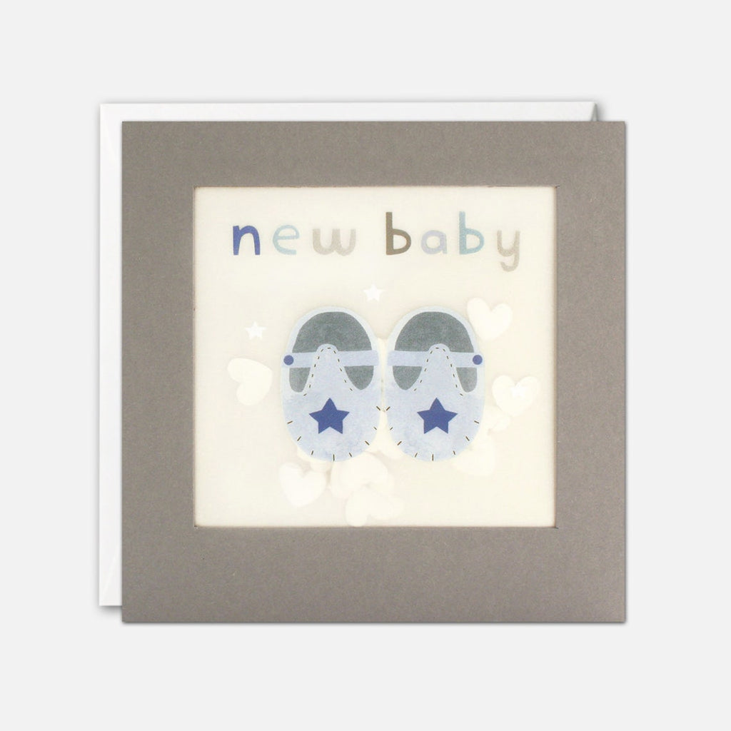 New Baby Blue Shoes Card - This sweet card features a pair of pink shoes and the words "New Baby" and is filled with white paper confetti stars. 