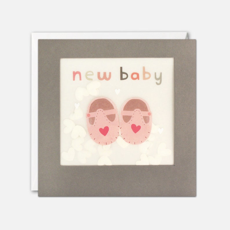 This sweet card features a pair of pink shoes and the words "New Baby" and is filled with white paper confetti stars.  Sold by Say It Baby Gifts