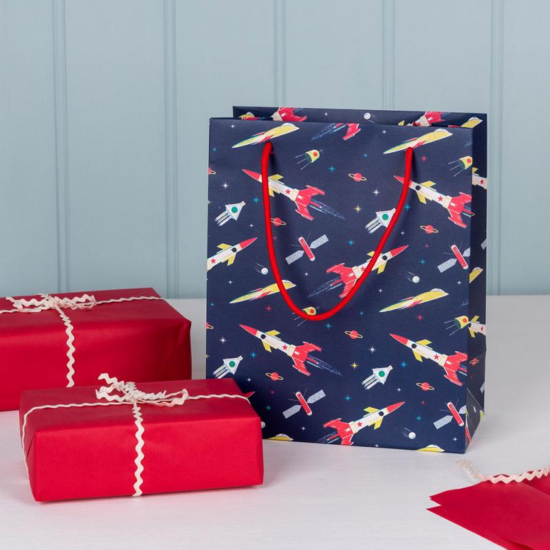 Small paper gift bag with red string handles and space age design by Rex London. Say It Baby Gifts