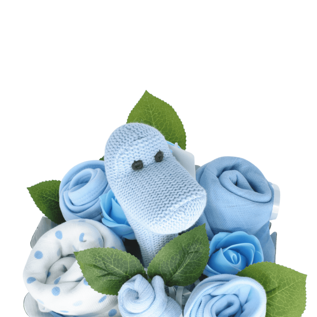 Say It Baby - Sweet Baby Blue Dino Bouquet. The bouquet box contains muslin squares, baby bibs, socks and a gorgeous Best Years Diplodocus Dino in blue The sweet dino is made from organic cotton and features a gentle rattle.