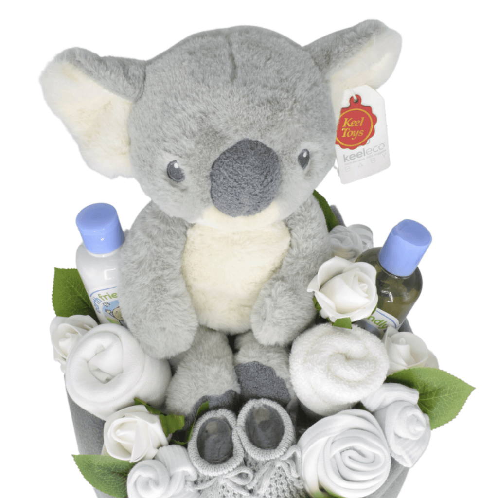 Unisex Baby Nappy Cake Bouquet - Grey. This nappy cake bouquet is sure to impress! Created using nappies and a soft baby blanket (and filled with lots of goodies), the gorgeous cake is then hand-wrapped in eco-friendly wrap with pretty ribbons and bow. A lovely gift for boy or girl.
